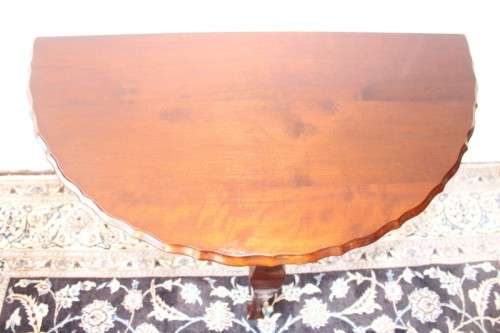A stylish vintage solid Imbuia ball and claw half moon display/occasional table w/ a scalloped edge