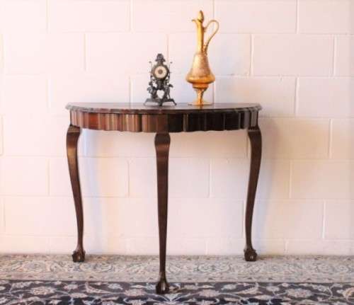 A stylish vintage solid Imbuia ball and claw half moon display/occasional table w/ a scalloped edge
