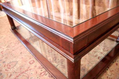 A fabulous, large glass top and bottom Mahogany coffee table with straight clean lines