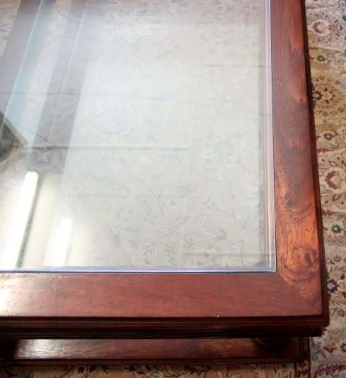 A fabulous, large glass top and bottom Mahogany coffee table with straight clean lines
