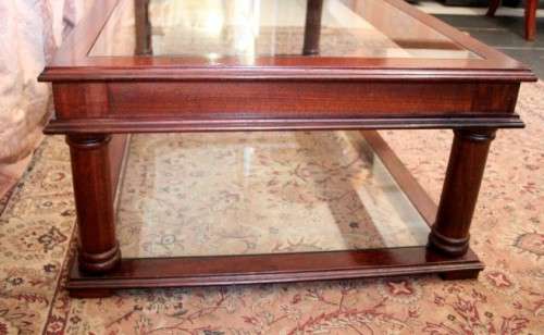 A fabulous, large glass top and bottom Mahogany coffee table with straight clean lines