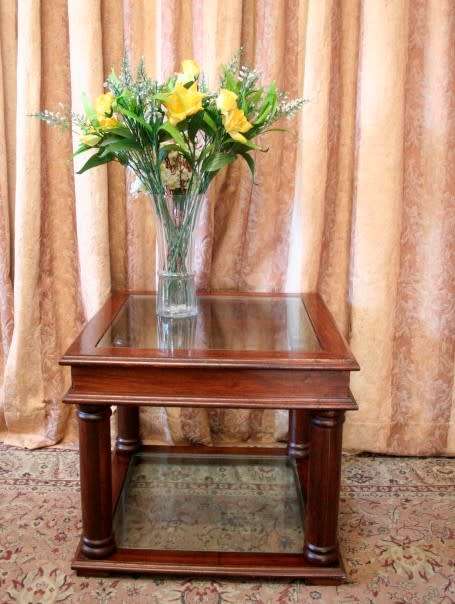 A stunning glass top and bottom Mahogany side table with straight clean lines