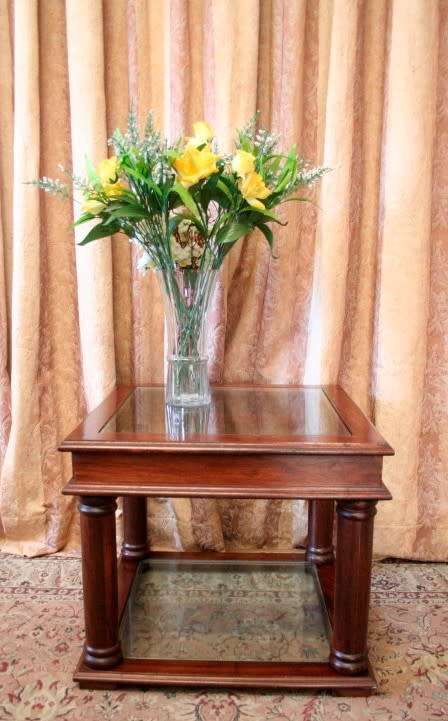 A stunning glass top and bottom Mahogany side table with straight clean lines