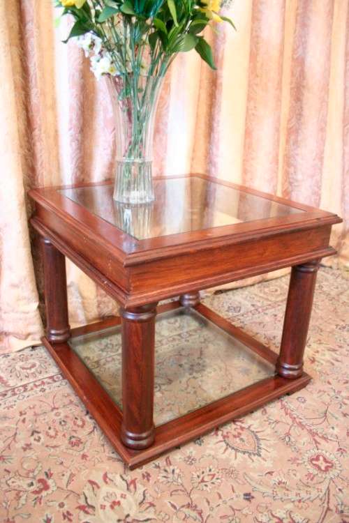 A stunning glass top and bottom Mahogany side table with straight clean lines