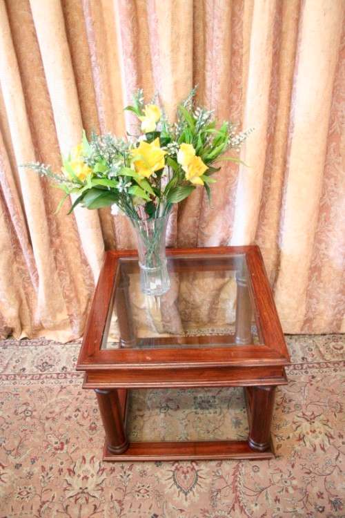 A stunning glass top and bottom Mahogany side table with straight clean lines