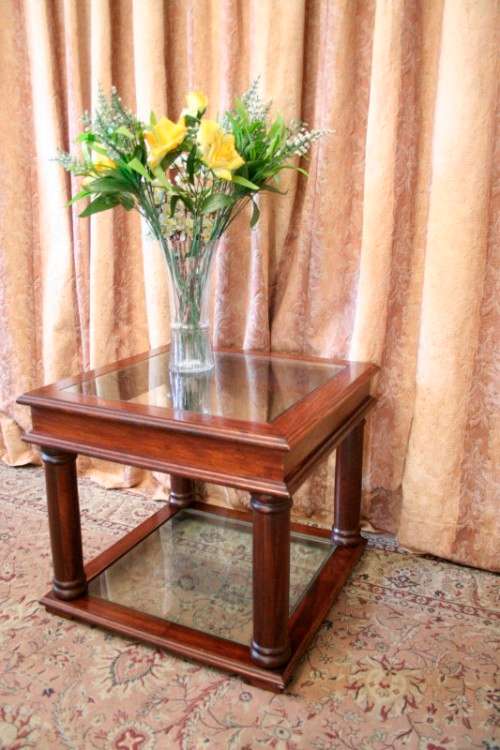 A stunning glass top and bottom Mahogany side table with straight clean lines