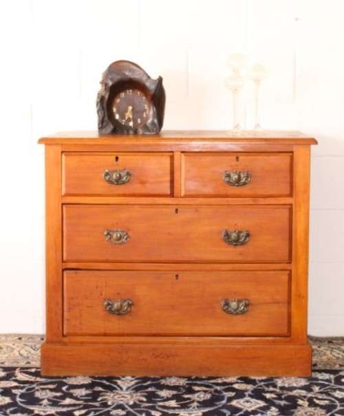 **RS17** An antique four-drawer (2-over-2) yellow wood chest of drawers w/ metal Art Nouveau handles