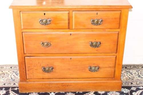 **RS17** An antique four-drawer (2-over-2) yellow wood chest of drawers w/ metal Art Nouveau handles
