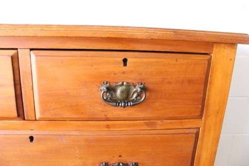 **RS17** An antique four-drawer (2-over-2) yellow wood chest of drawers w/ metal Art Nouveau handles