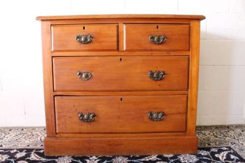 **RS17** An antique four-drawer (2-over-2) yellow wood chest of drawers w/ metal Art Nouveau handles