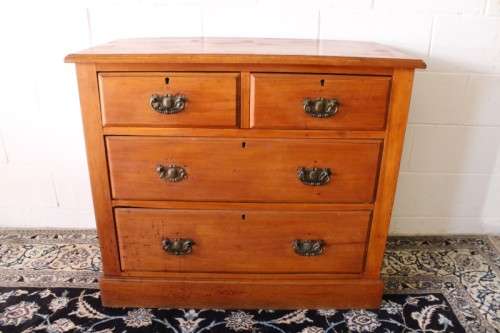 **RS17** An antique four-drawer (2-over-2) yellow wood chest of drawers w/ metal Art Nouveau handles