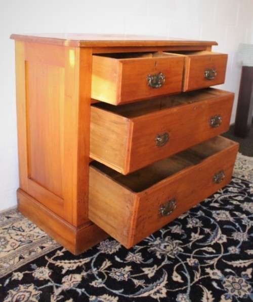 **RS17** An antique four-drawer (2-over-2) yellow wood chest of drawers w/ metal Art Nouveau handles