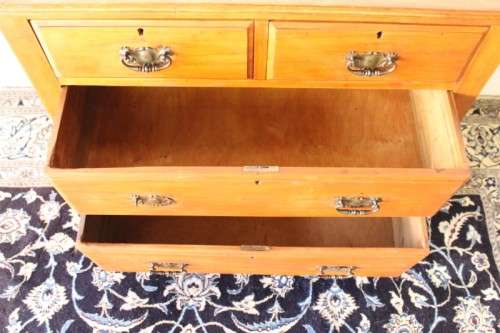 **RS17** An antique four-drawer (2-over-2) yellow wood chest of drawers w/ metal Art Nouveau handles