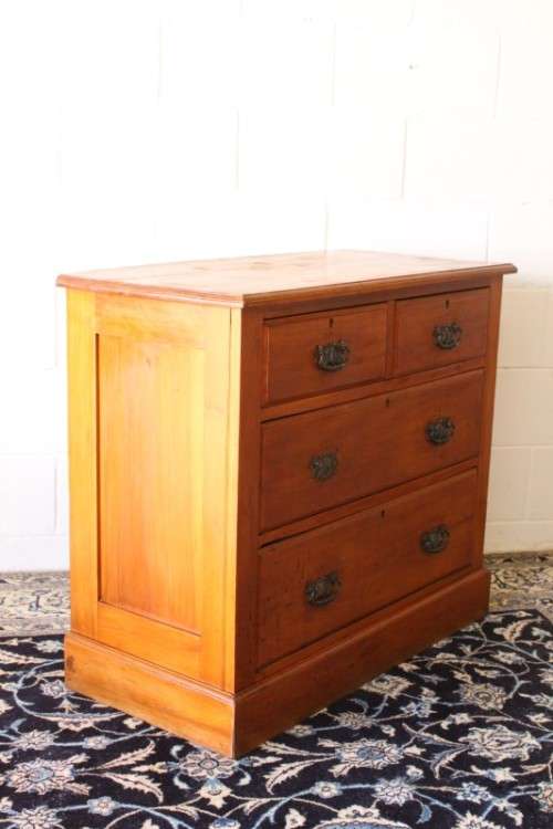 **RS17** An antique four-drawer (2-over-2) yellow wood chest of drawers w/ metal Art Nouveau handles