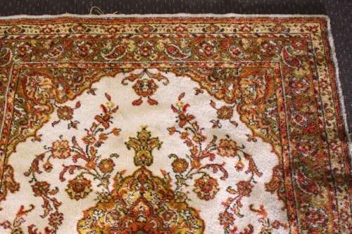 A vintage 189cm x 132cm Persian styled carpet w/ dark greens, marigold yellow, rust & earthy colours