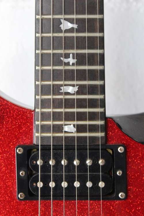 A awesome PRS SE Orianthi signature "red sparkle" electric guitar in good condition w/ carry bag!