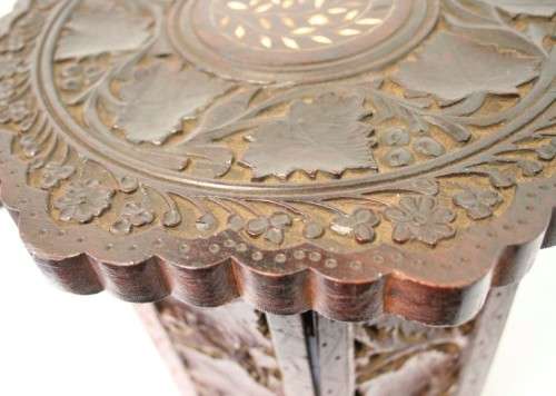 **RS17** A carved round Indian wood occasional/ side table with inlay detail and a hexagon base.