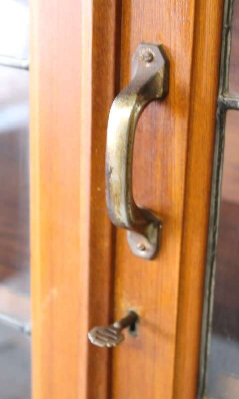 **RS17** A vintage Art Deco 3-fixed shelf double door book cabinet with lead-glass door detailing