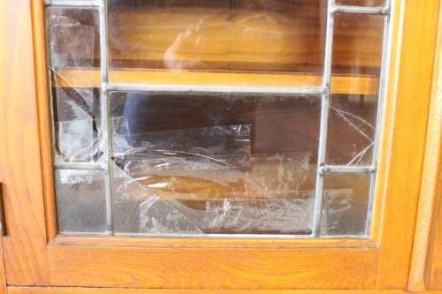 **RS17** A vintage Art Deco 3-fixed shelf double door book cabinet with lead-glass door detailing