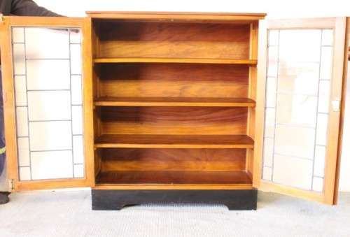 **RS17** A vintage Art Deco 3-fixed shelf double door book cabinet with lead-glass door detailing