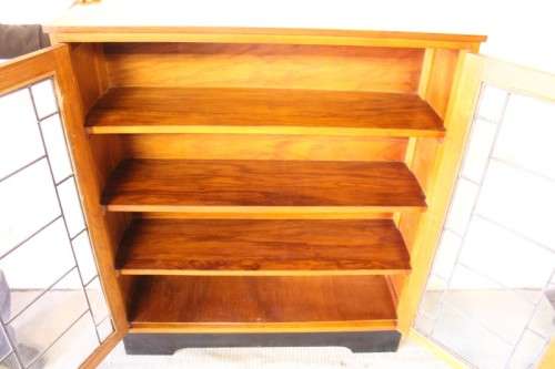 **RS17** A vintage Art Deco 3-fixed shelf double door book cabinet with lead-glass door detailing