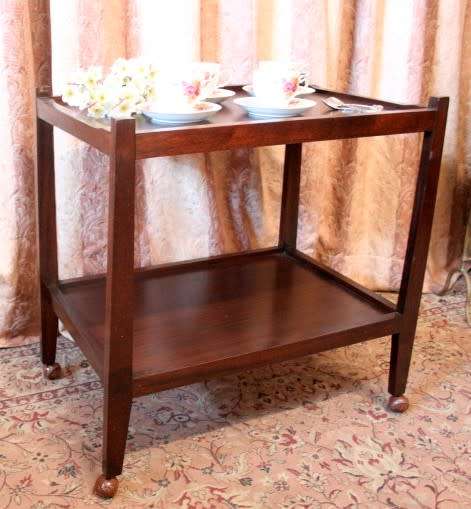 A lovely vintage wooden butlers trolley on wheels, perfect drinks/snacks trolley.