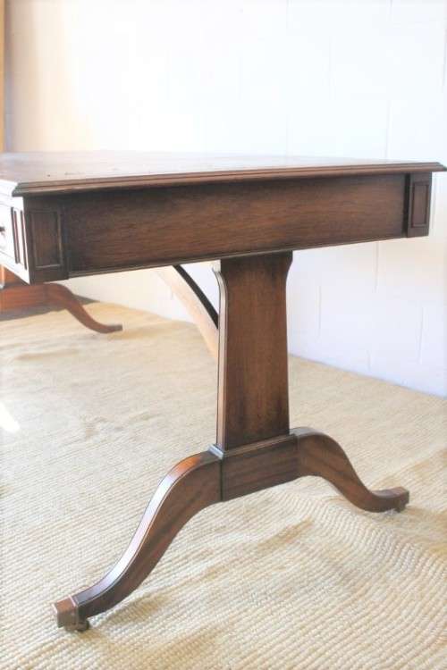 A beautiful vintage Regency styled ladies embossed leather-top 3-drawer writing desk on castors