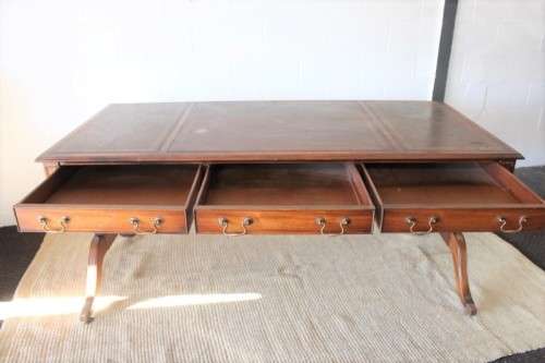 A beautiful vintage Regency styled ladies embossed leather-top 3-drawer writing desk on castors