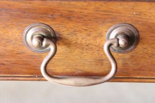 A beautiful vintage Regency styled ladies embossed leather-top 3-drawer writing desk on castors