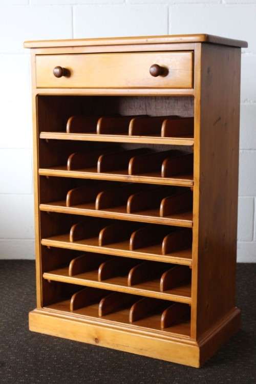 An incredible and beautifully made solid oregon wood 30-bottle wine rack with a smalls drawer