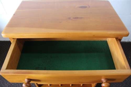 An incredible and beautifully made solid oregon wood 30-bottle wine rack with a smalls drawer