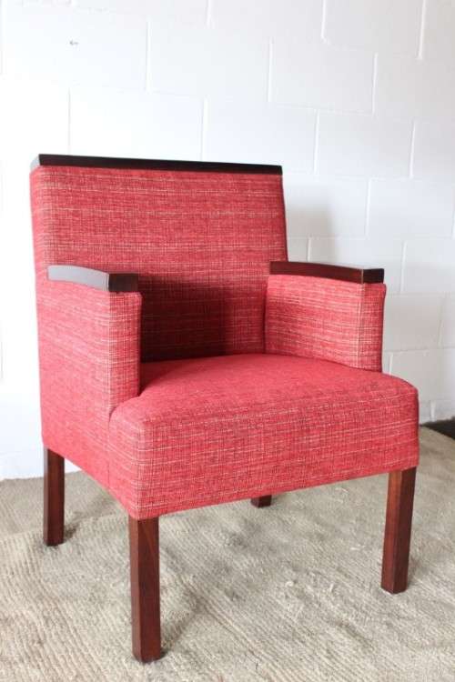An awesome & stylish mid-century styled red-upholstered club armchair w/ mahogany armrests