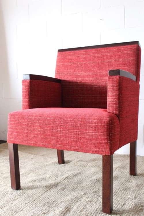 An awesome & stylish mid-century styled red-upholstered club armchair w/ mahogany armrests
