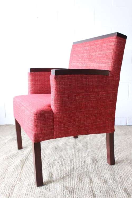 An awesome & stylish mid-century styled red-upholstered club armchair w/ mahogany armrests