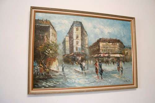 A beautiful framed original signed oil painting of a town scene.