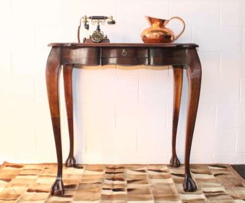 A beautiful tall (91cm) antique solid stink-wood & yellow-wood ball and claw hall table w/ a drawer