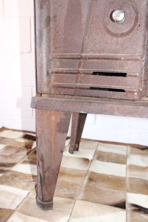An exceptionally rare antique cast iron two-door coal stove with a chimney vent and removable grates