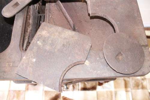 An exceptionally rare antique cast iron two-door coal stove with a chimney vent and removable grates