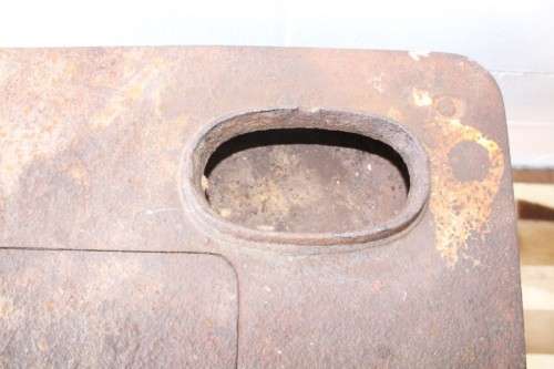 An exceptionally rare antique cast iron two-door coal stove with a chimney vent and removable grates