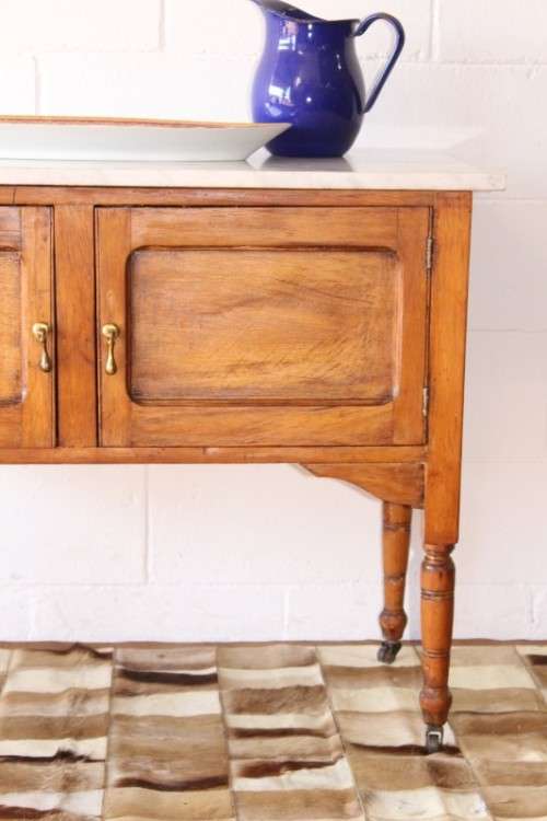A wonderful vintage solid Oak double door wash stand with a white marble top on castors - stunning!