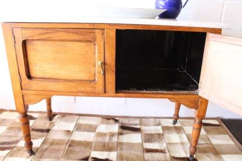 A wonderful vintage solid Oak double door wash stand with a white marble top on castors - stunning!