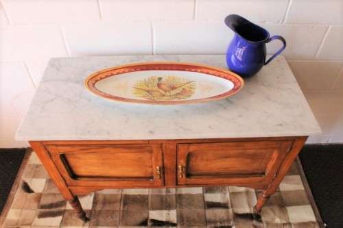 A wonderful vintage solid Oak double door wash stand with a white marble top on castors - stunning!