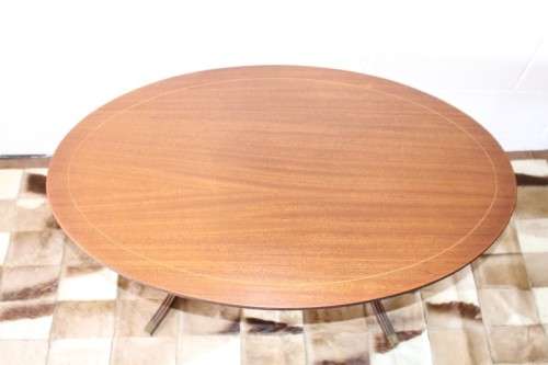 A wonderful vintage Regency style oval coffee table with brass-caped toes and rail inlay detailing
