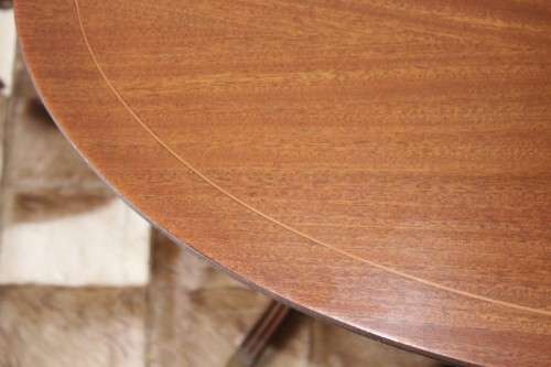A wonderful vintage Regency style oval coffee table with brass-caped toes and rail inlay detailing