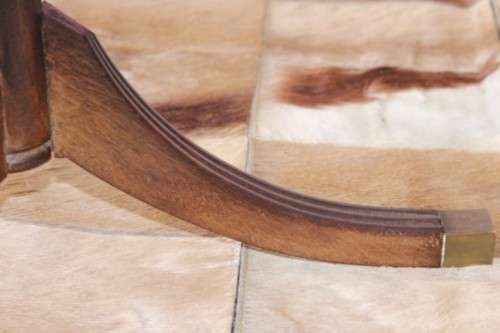 A wonderful vintage Regency style oval coffee table with brass-caped toes and rail inlay detailing