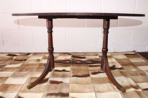 A wonderful vintage Regency style oval coffee table with brass-caped toes and rail inlay detailing