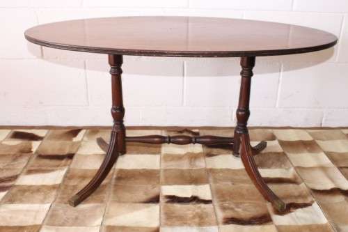 A wonderful vintage Regency style oval coffee table with brass-caped toes and rail inlay detailing