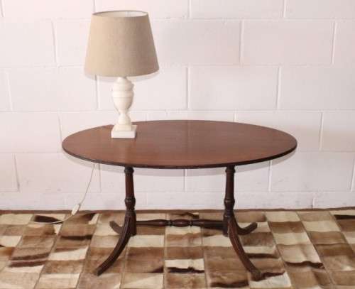 A wonderful vintage Regency style oval coffee table with brass-caped toes and rail inlay detailing