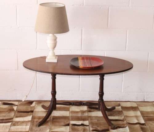 A wonderful vintage Regency style oval coffee table with brass-caped toes and rail inlay detailing