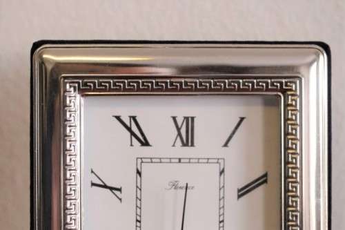A stunning ornately detailed sterling silver framed "Florence" free-standing quartz alarm clock